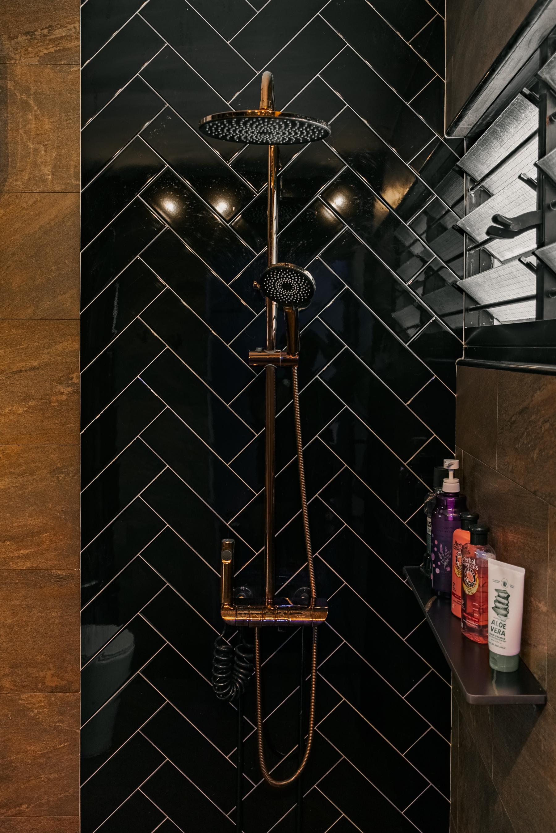 Eclectic Bathroom with Herringbone Tiling and Rainshower