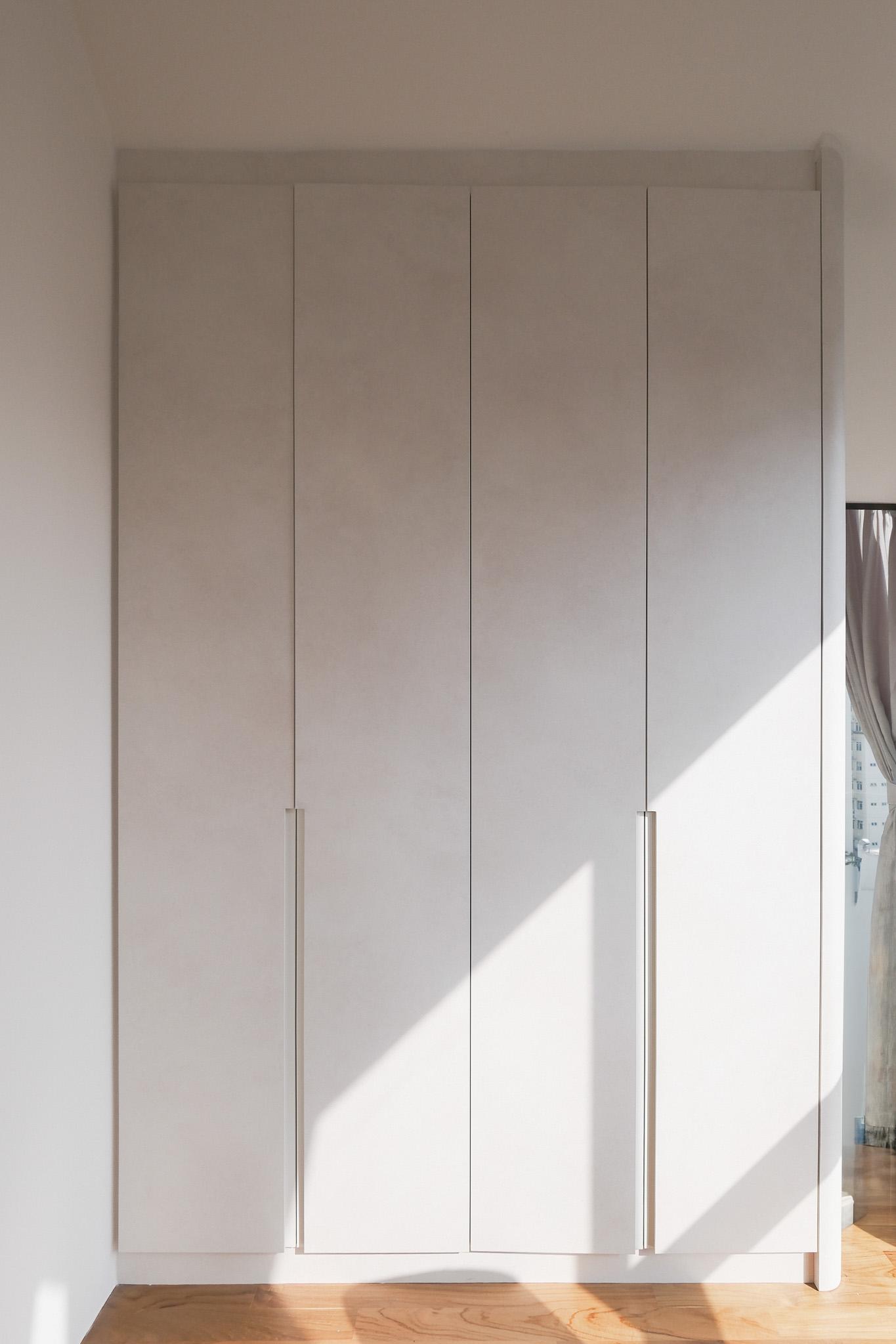 Minimalist Bedroom with Parquet Floor and Drop Light