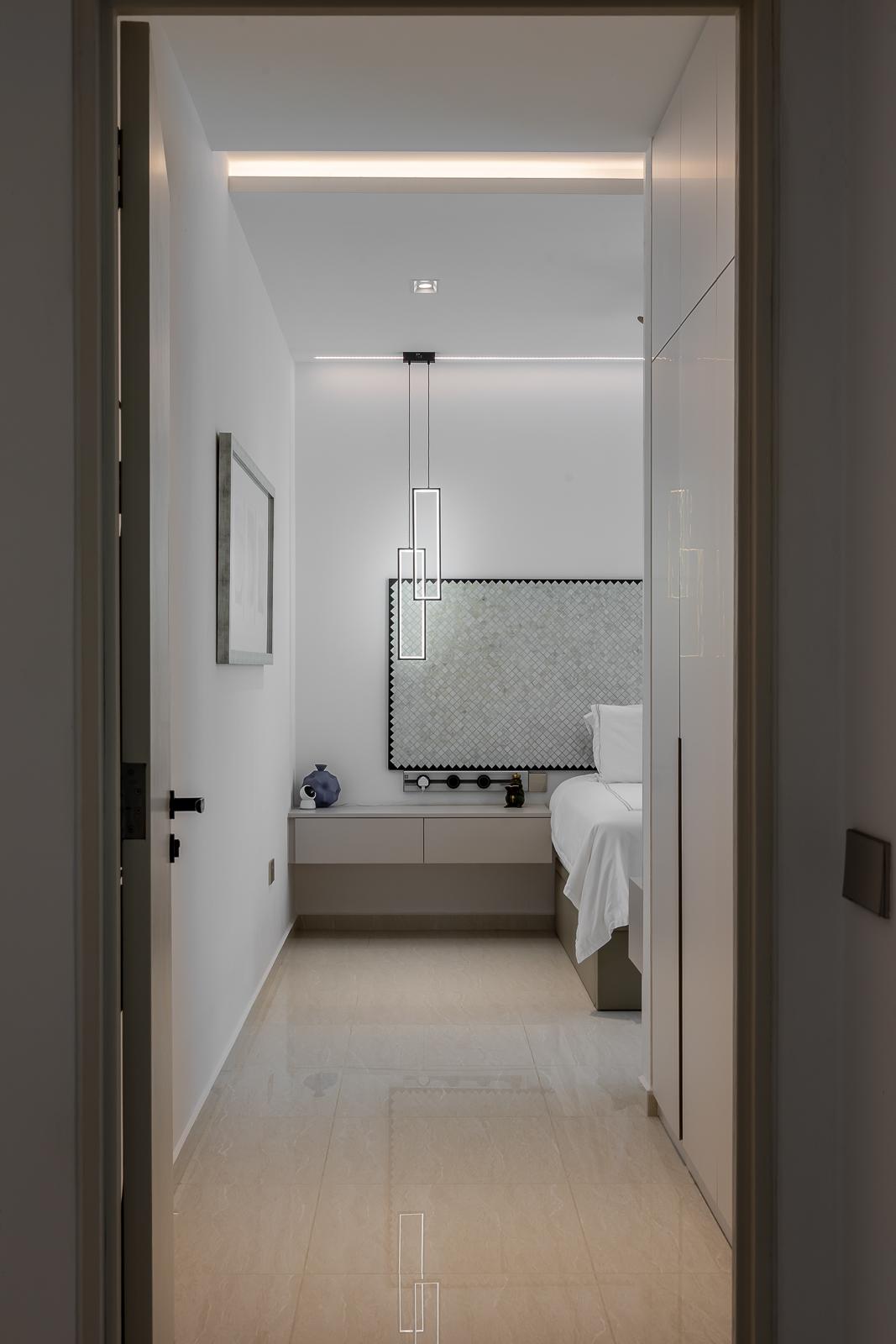 Modern Bedroom with Homogeneous Tiles and Cove Lighting
