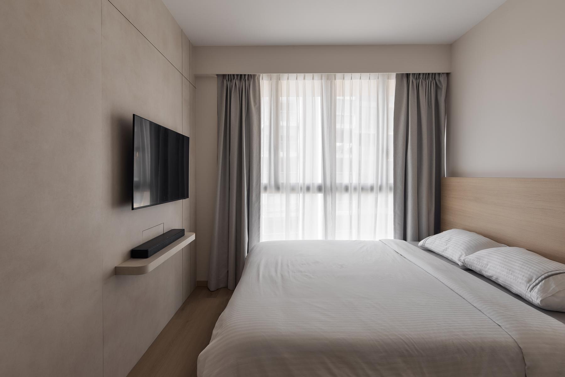 Asian Bedroom with Wood Flooring and TV