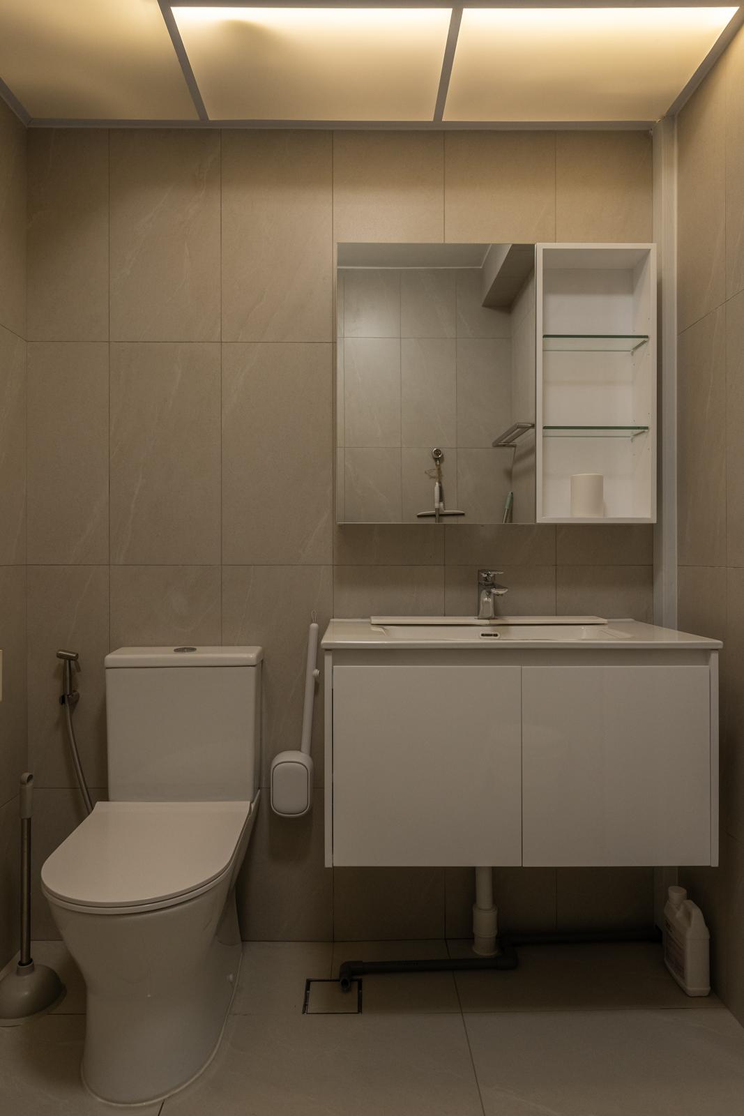 Minimalist Bathroom with Homogeneous Tiles and Bathroom Storage