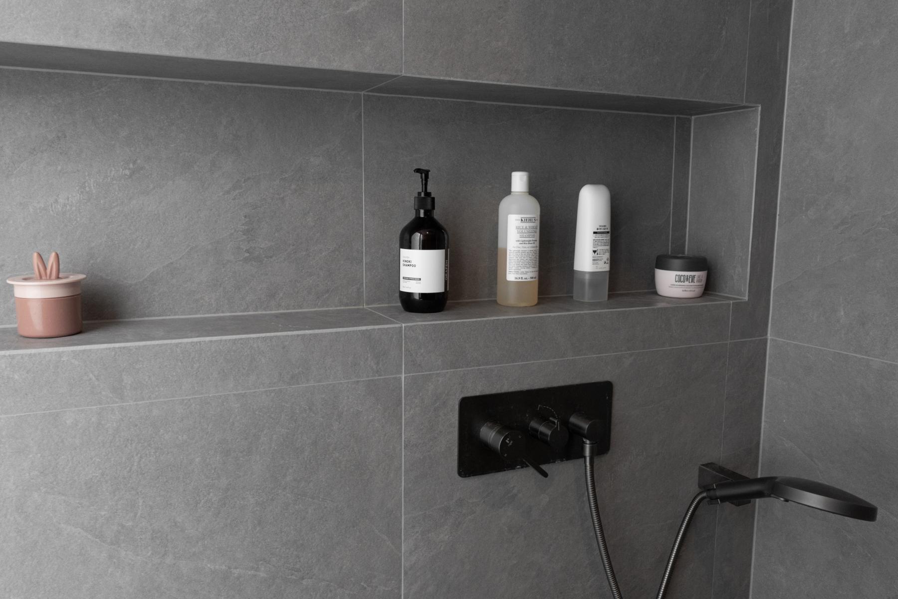 Scandinavian Bathroom with Homogeneous Tiles and Rainshower