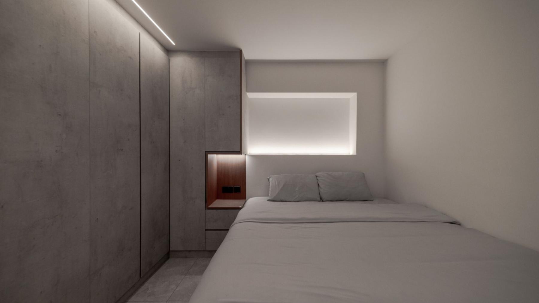 Modern Bedroom with Homogeneous Tiles and Cove Lighting