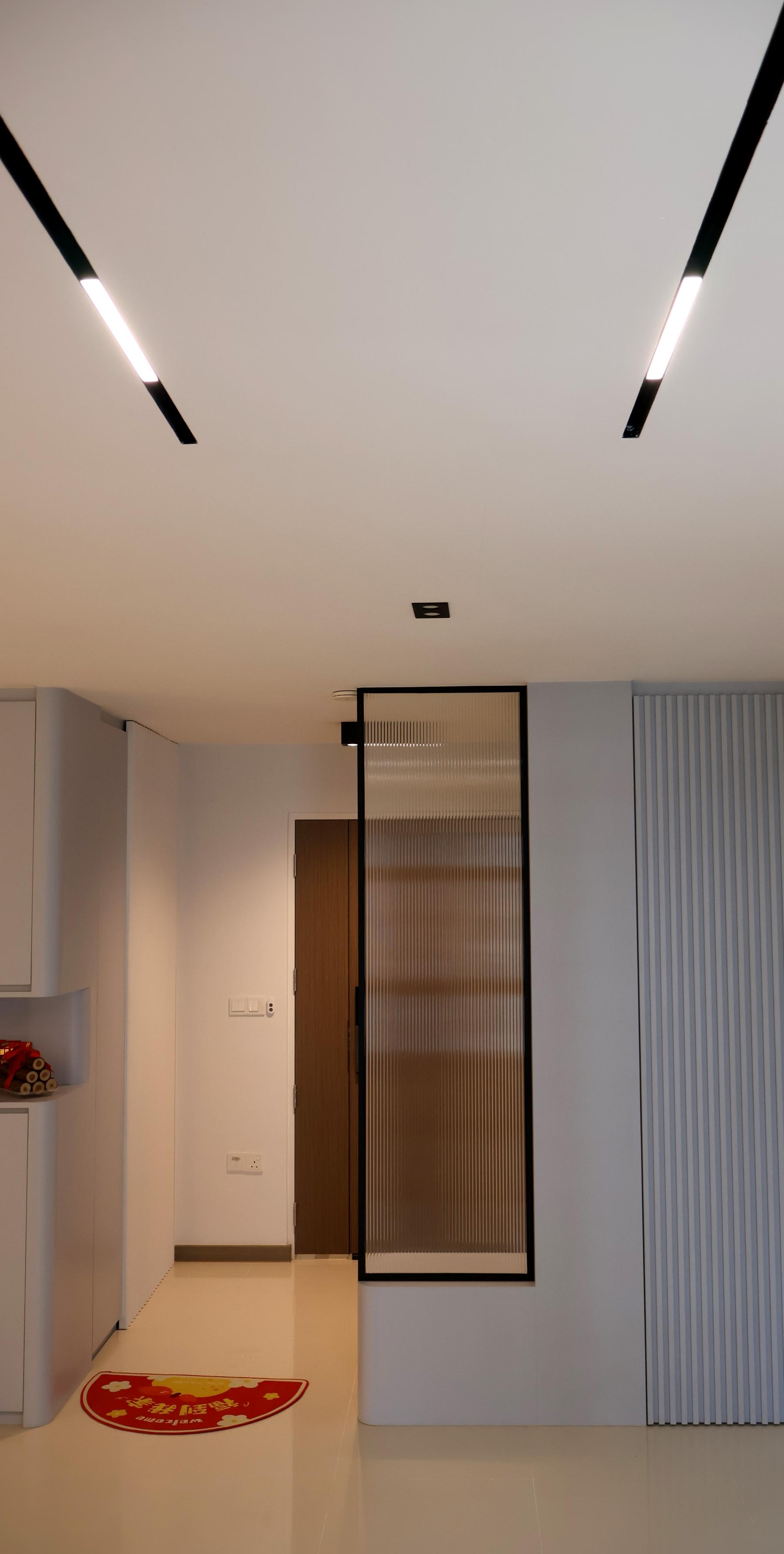 Minimalist Hallway with Homogeneous Tiles and Cove Lighting