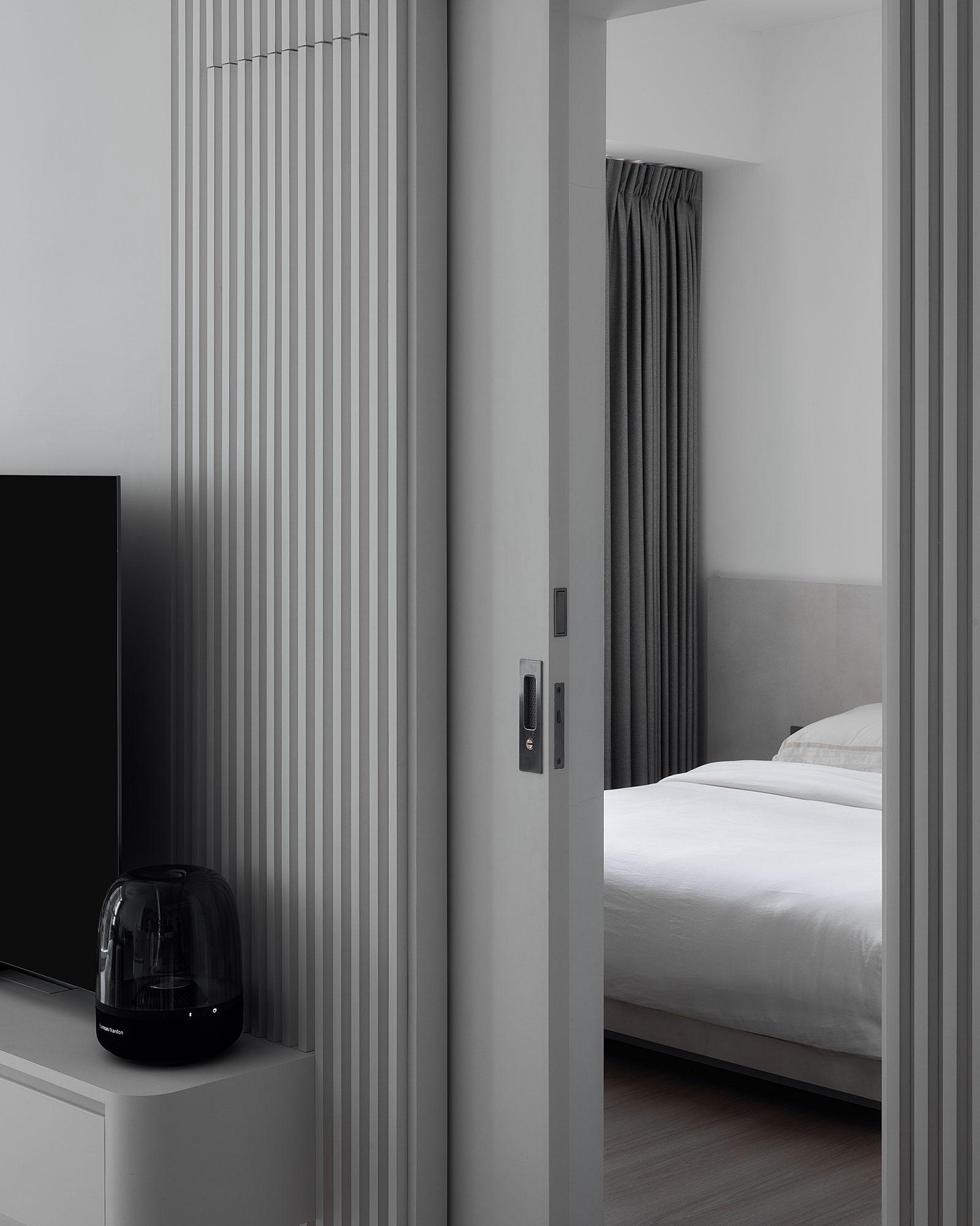 Minimalist Bedroom with Wood Flooring and Drop Ceiling