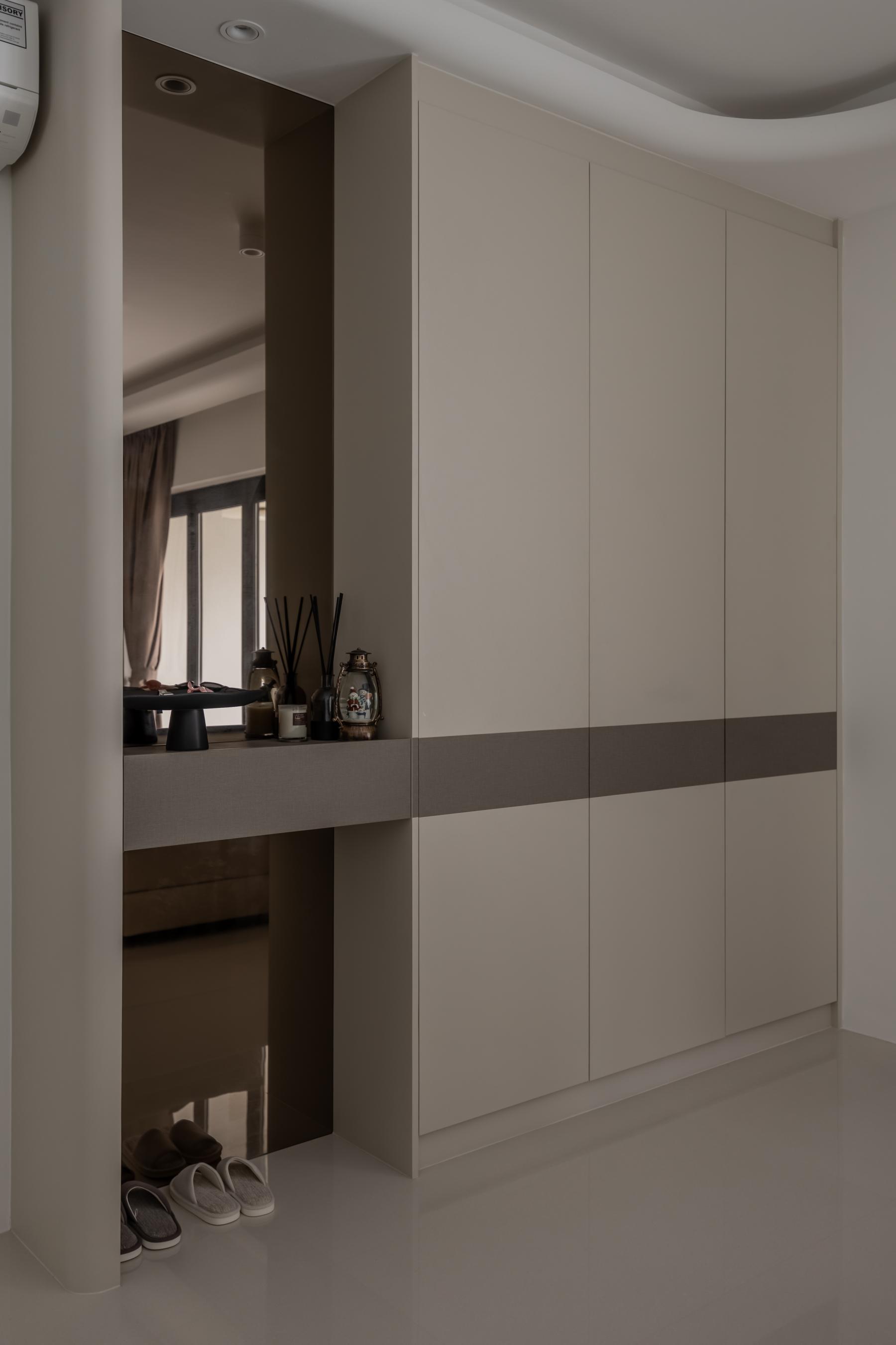 Modern Foyer with Cove Lighting and Storage Cabinets