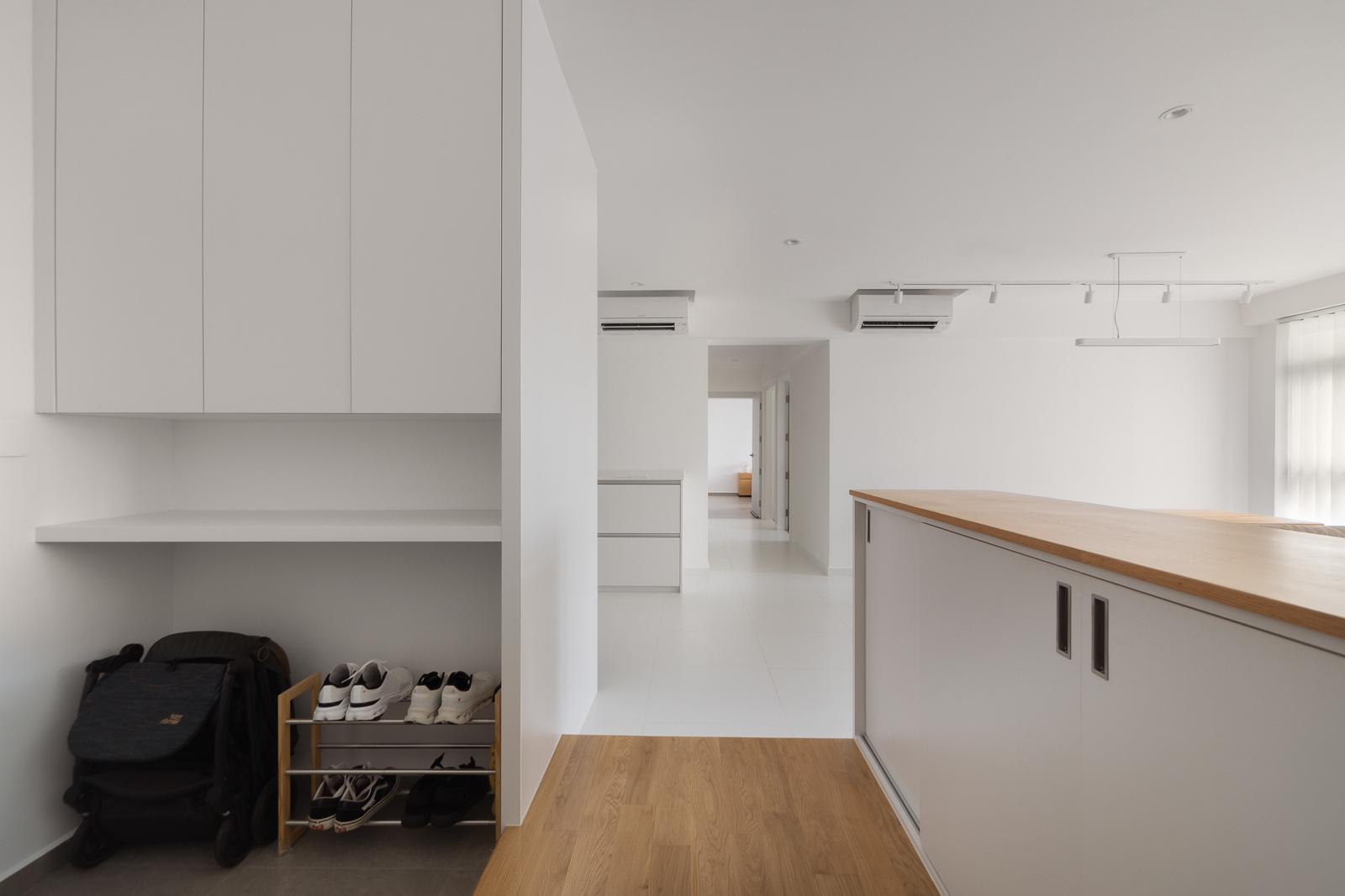 Minimalist Entryway with Wood Flooring and Shoe Rack
