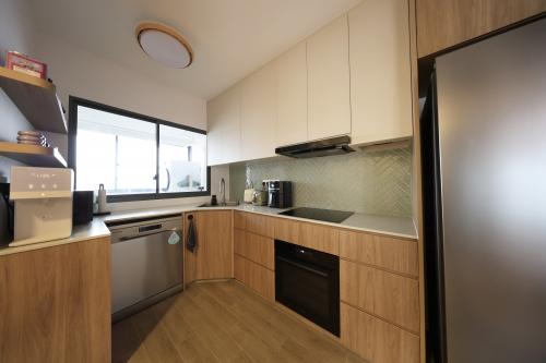 Minimalist Kitchen at 4 Room BTO @ Tampines Green Jade