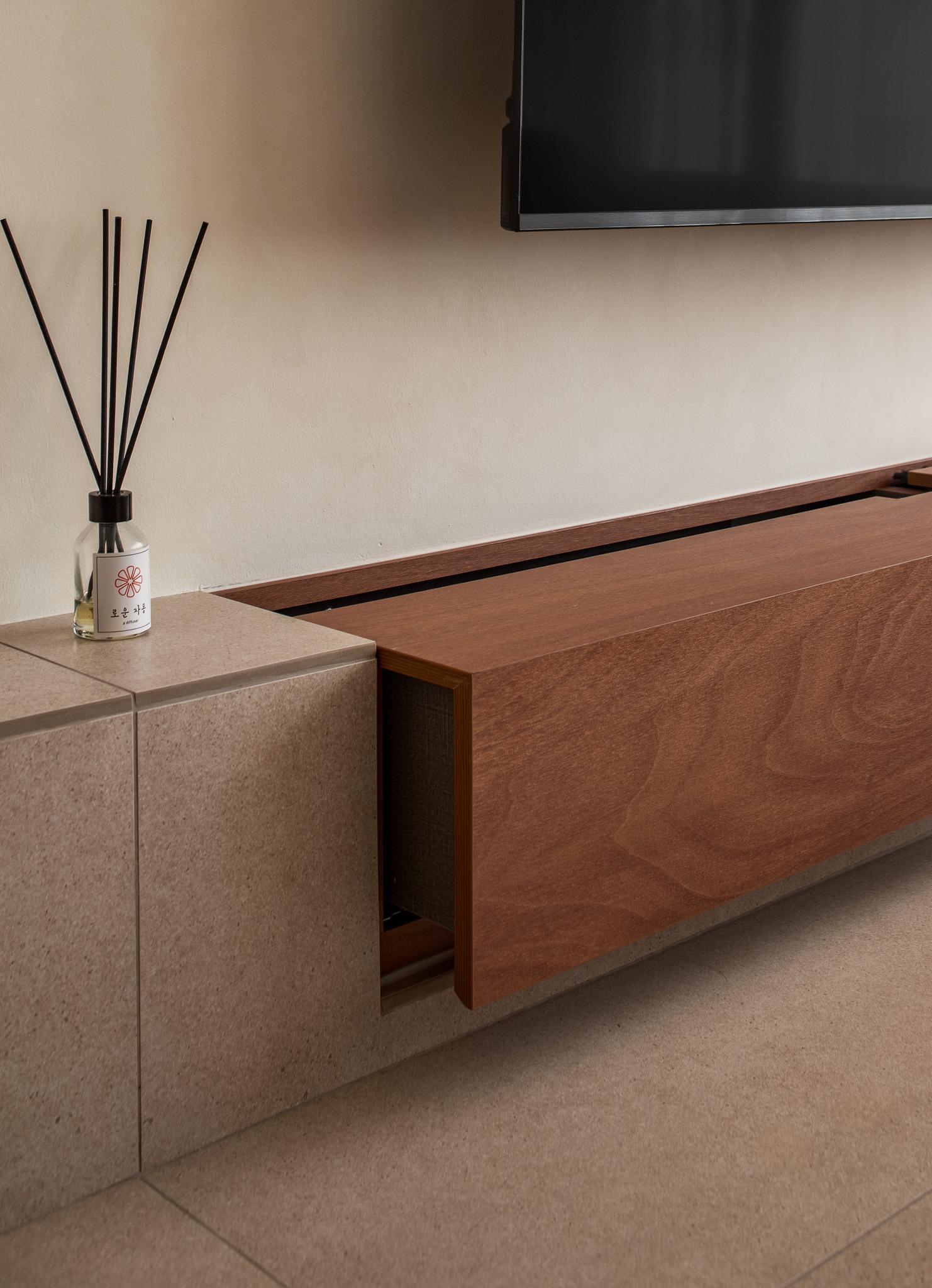 Scandinavian Living Room with Homogeneous Tiles and TV Console