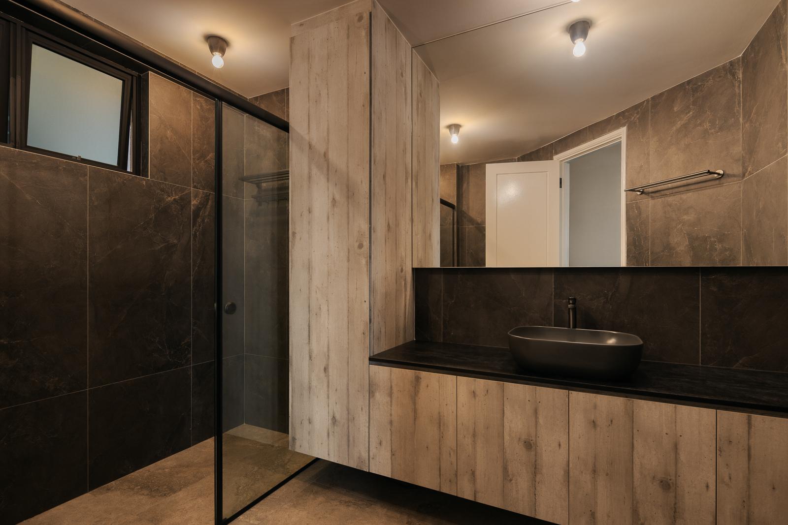 Industrial Bathroom with Homogeneous Tiles and Mirror