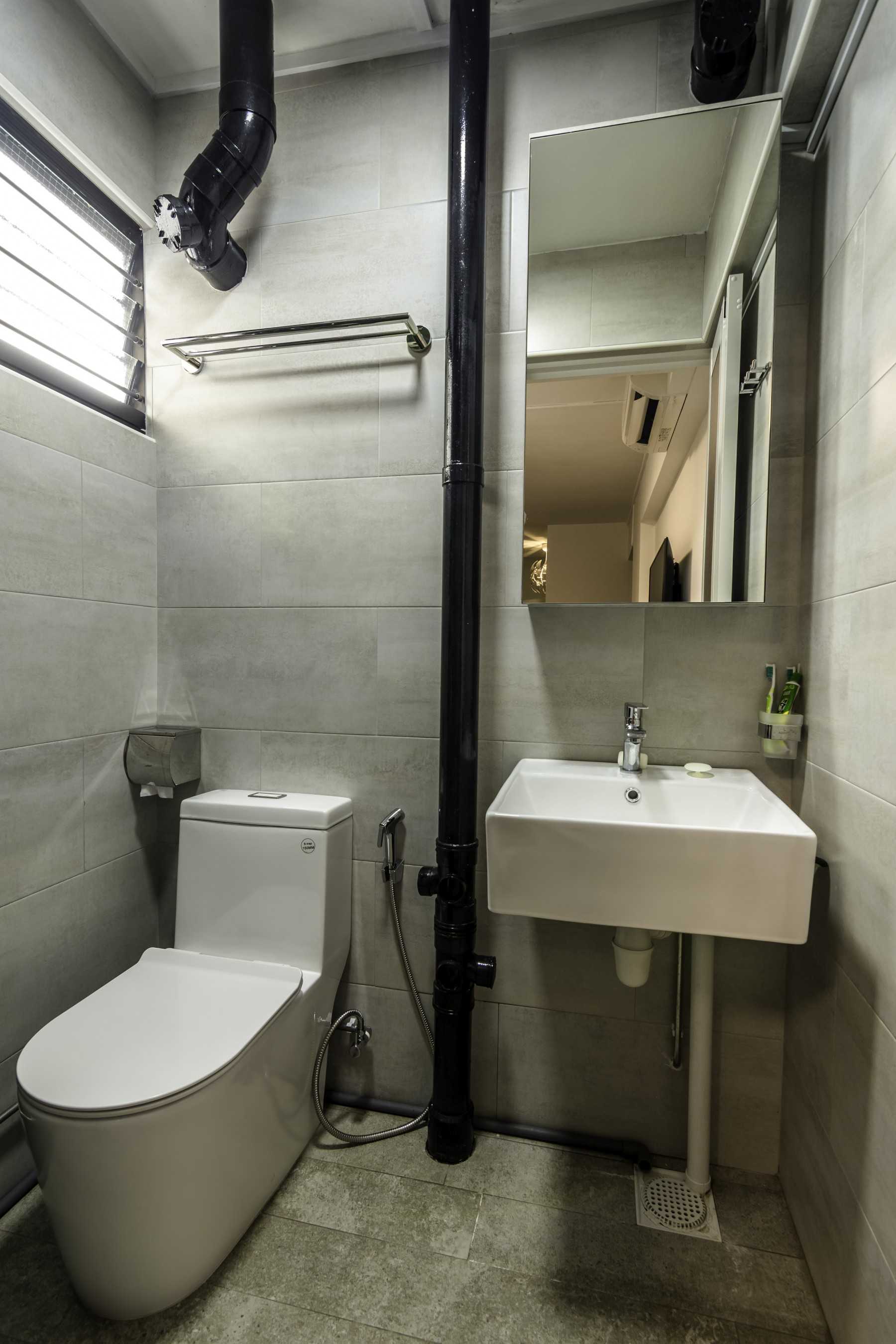 Industrial Bathroom with Homogeneous Tiles and Mirror