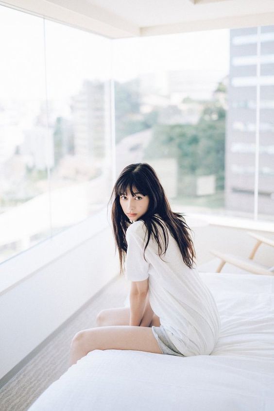 girl sitting on bed