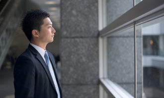 businessman-looking-out-the-window-iStock