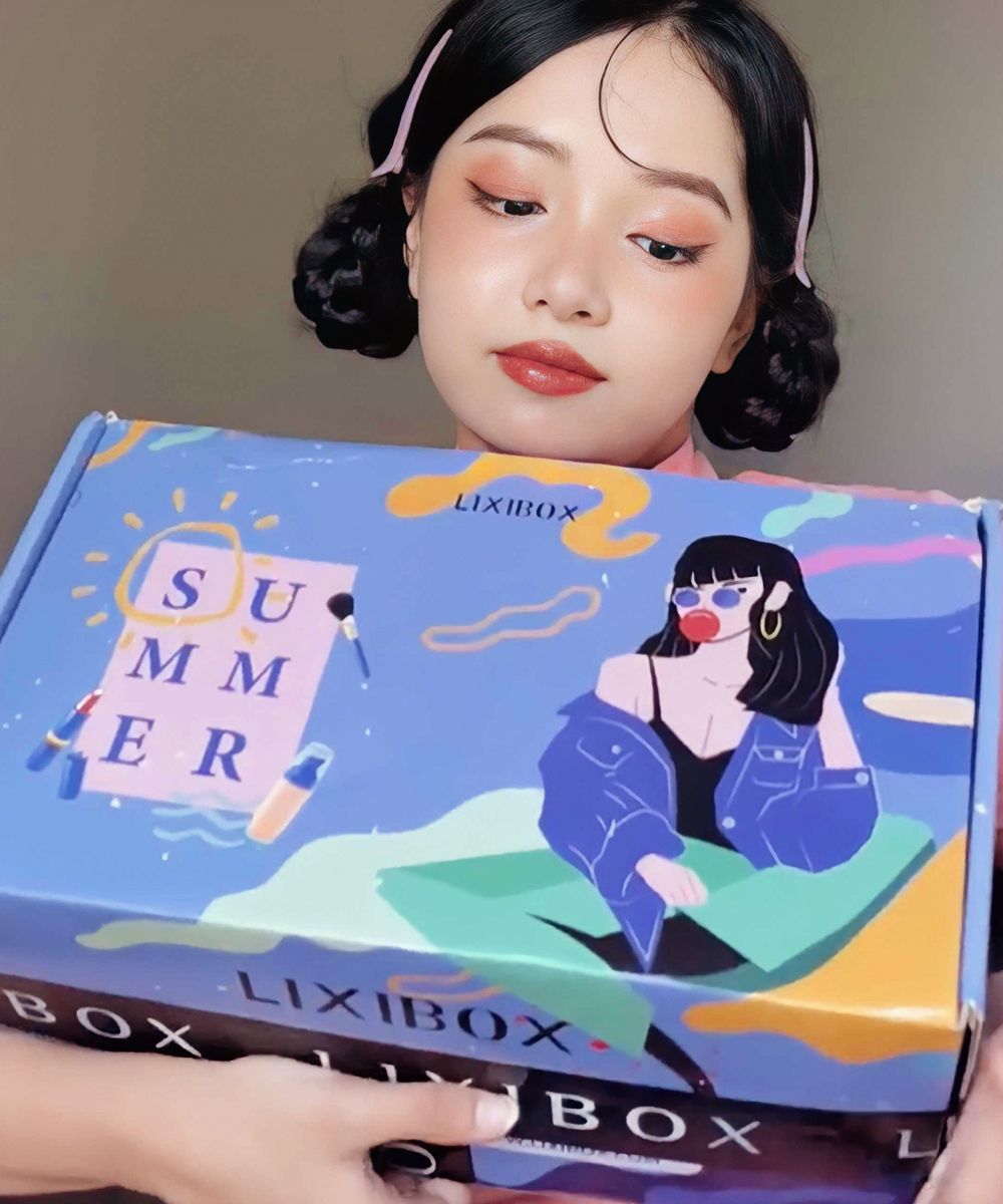 Beauty TikToker đang cầm hộp quà GWP từ Lixibox với thiết kế màu sắc nổi bật, chia sẻ trải nghiệm săn quà tặng khi mua sắm mỹ phẩm chính hãng, tận hưởng ưu đãi mùa hè hấp dẫn từ Lixibox.