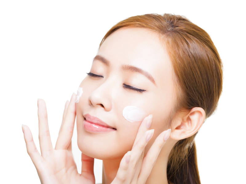 asian woman applying cream