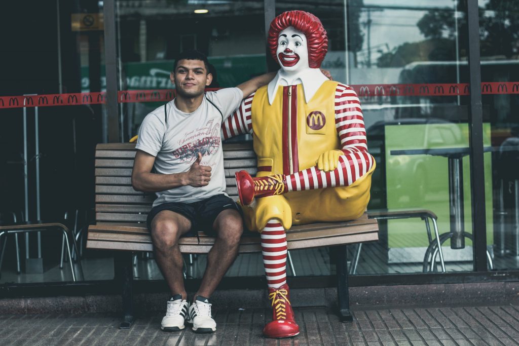 Customer Experience Strategies in 2021 - man sitting next to ronald macdonald