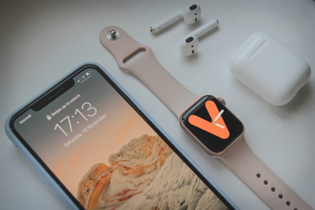 Image showing an iPhone, Apple Watch and AirPods.