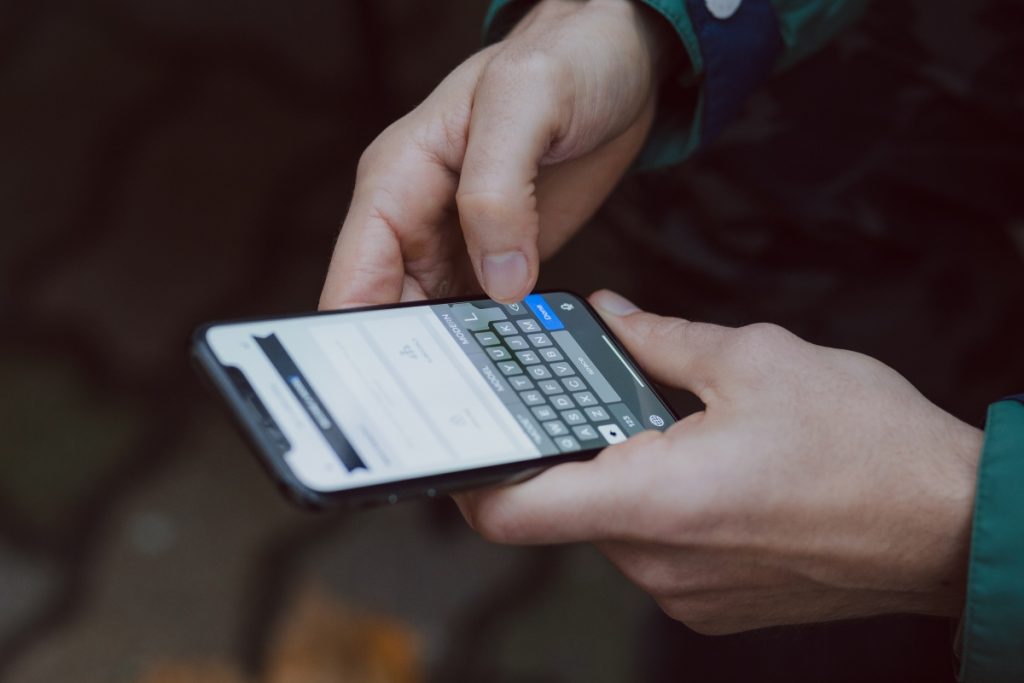 Image showing an iPhone user writing an email.
