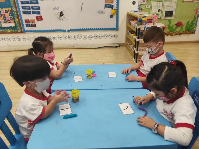 MindChamps PreSchool children learning the strokes of Chinese characters.
