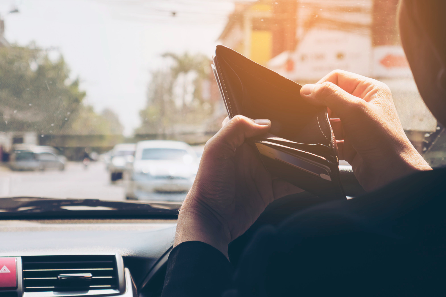 Editors%2 Fimages%2 F1695374151515 Man Look His Empty Wallet While Driving Car Dangerous Behavior