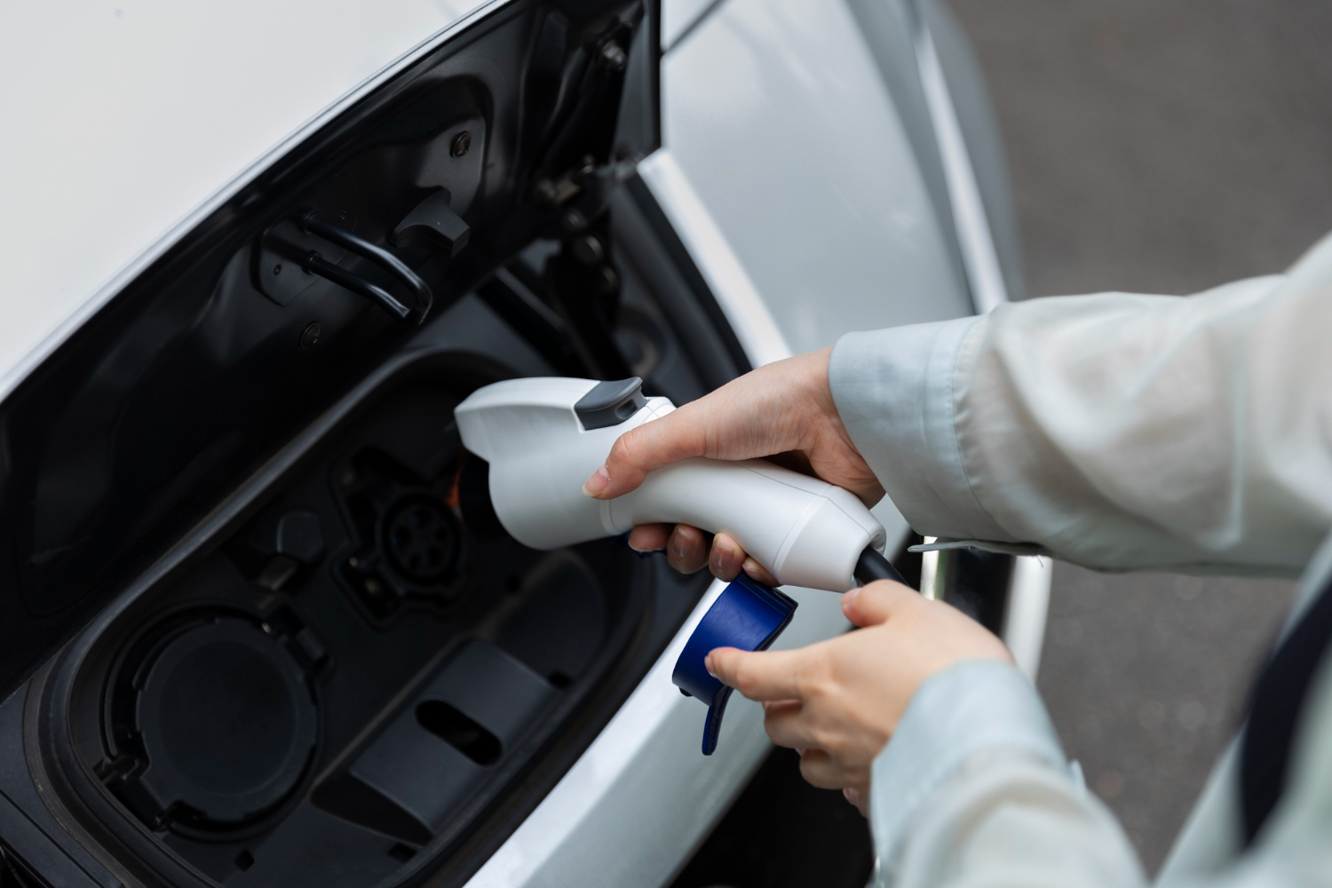 Editors%2 Fimages%2 F1708660912659 Woman Charging Her Electric Car Station