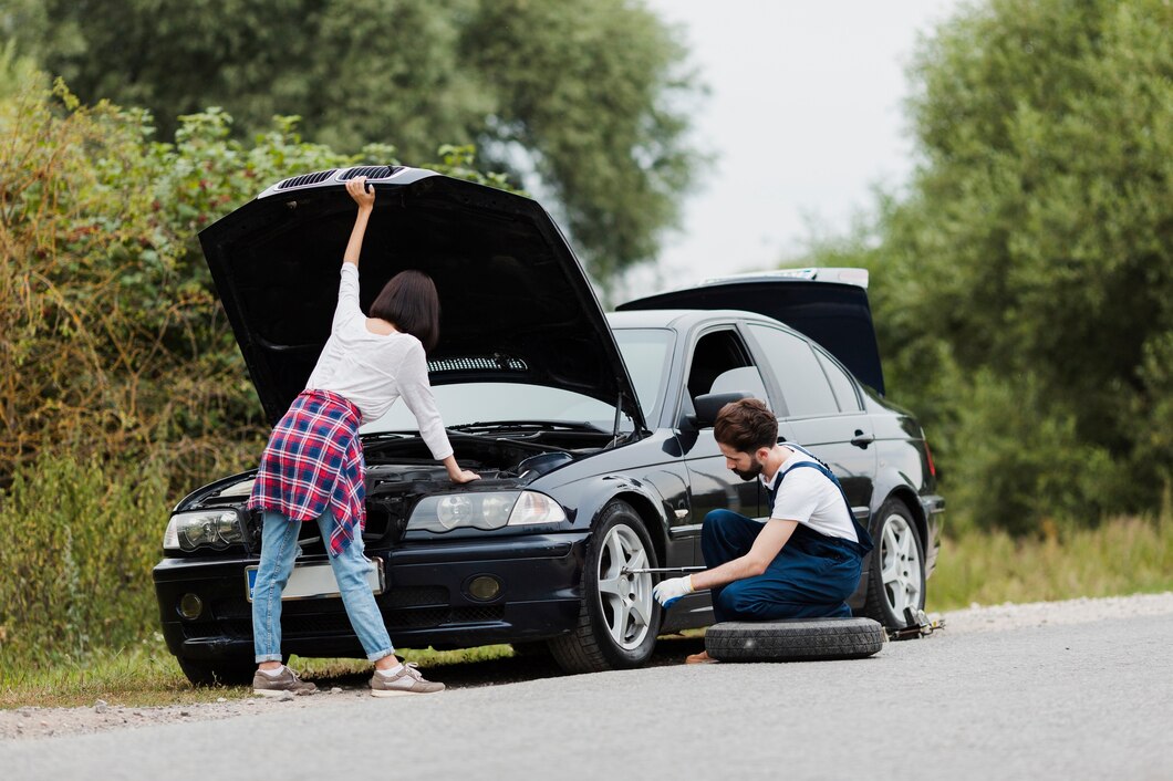 Editors%2 Fimages%2 F1715669657161 Woman Checking Engine Man Swapping Tire 23 2148270688