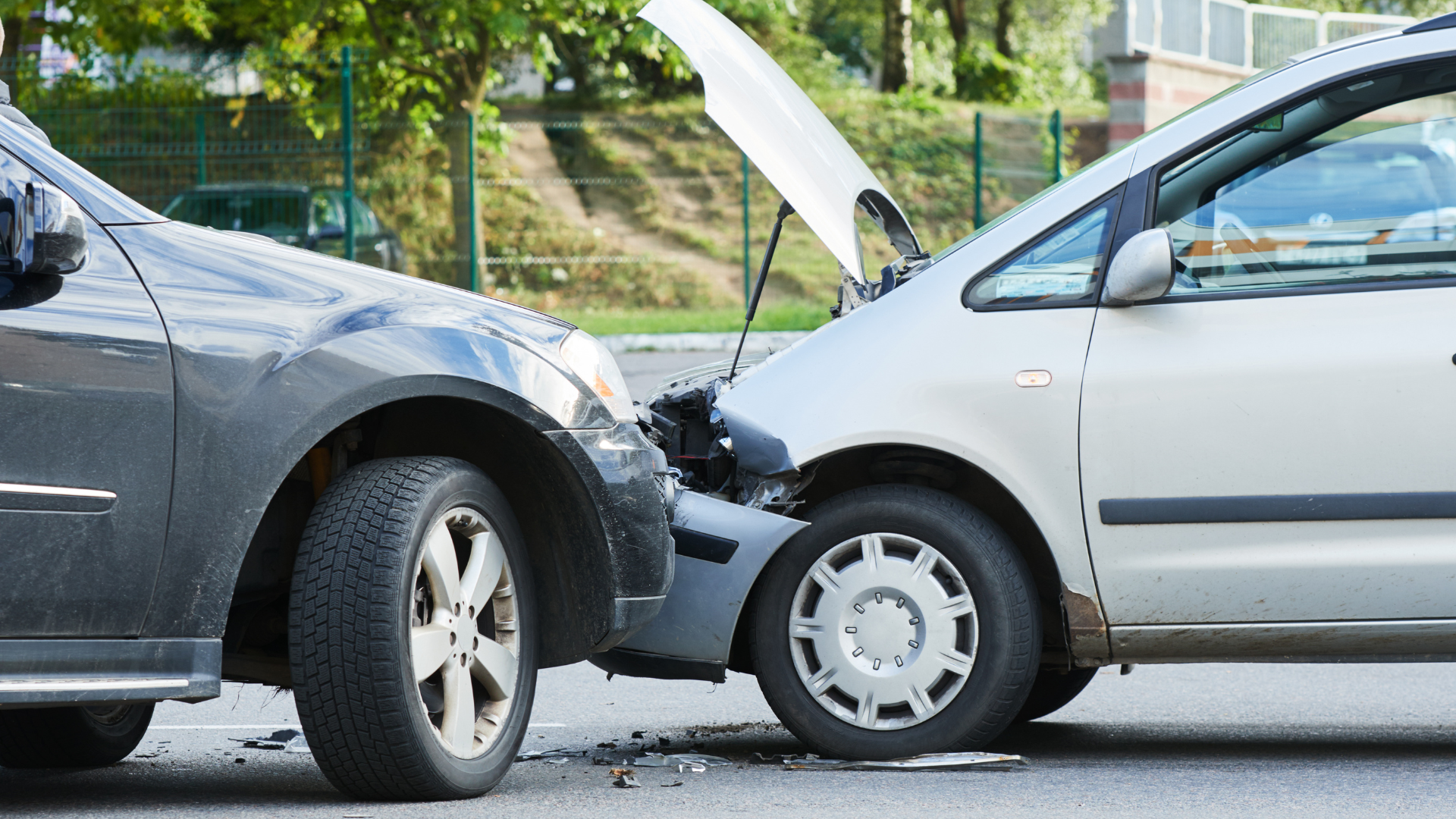 A driver documenting a traffic accident scene, with police taking notes and vehicles involved in the background, illustrating the steps to take after a traffic accident in Malaysia