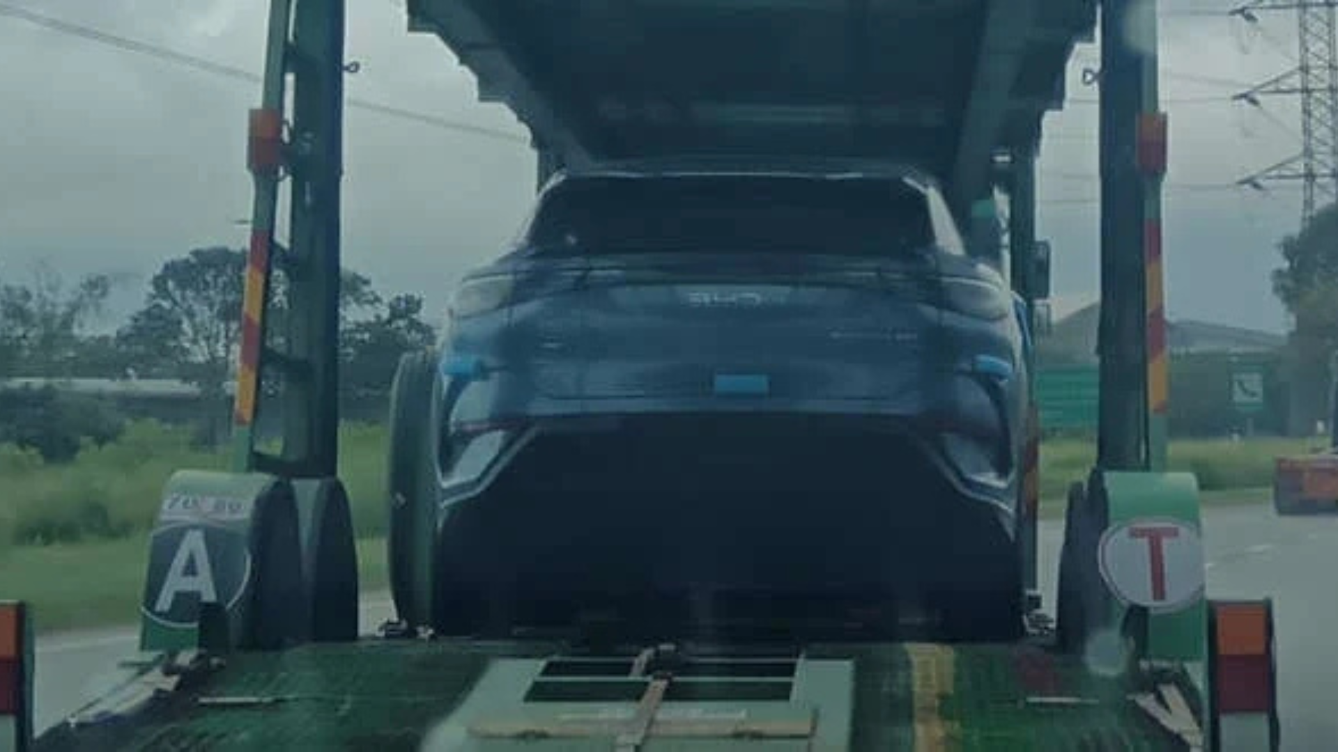 A sleek and modern BYD Sealion 7 EV parked on a picturesque Malaysian street, showcasing its dynamic design and commitment to sustainable transportation.