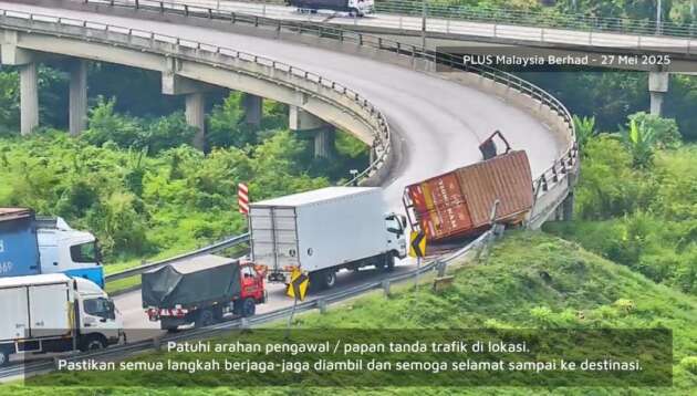 Lorry accident scene at NKVE Shah Alam interchange causing major traffic jam with emergency vehicles on site