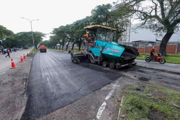 Malaysian federal road maintenance project showing road repair work and construction equipment under RM350 million government budget allocation