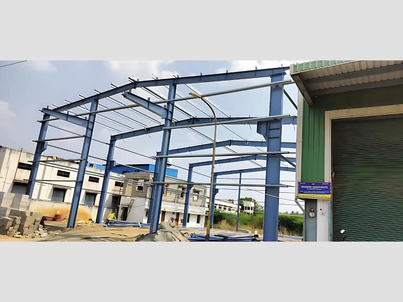 Blue PEB Structure Side View With Integrated Wall Cladding Support