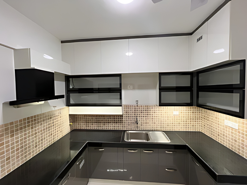 Premium L-shaped modular kitchen with high gloss finish cabinets