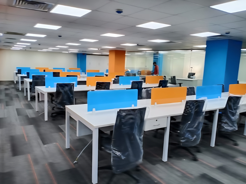 Corporate Office Workstation Setup With Blue And Orange Privacy Panels And Ergonomic Chairs