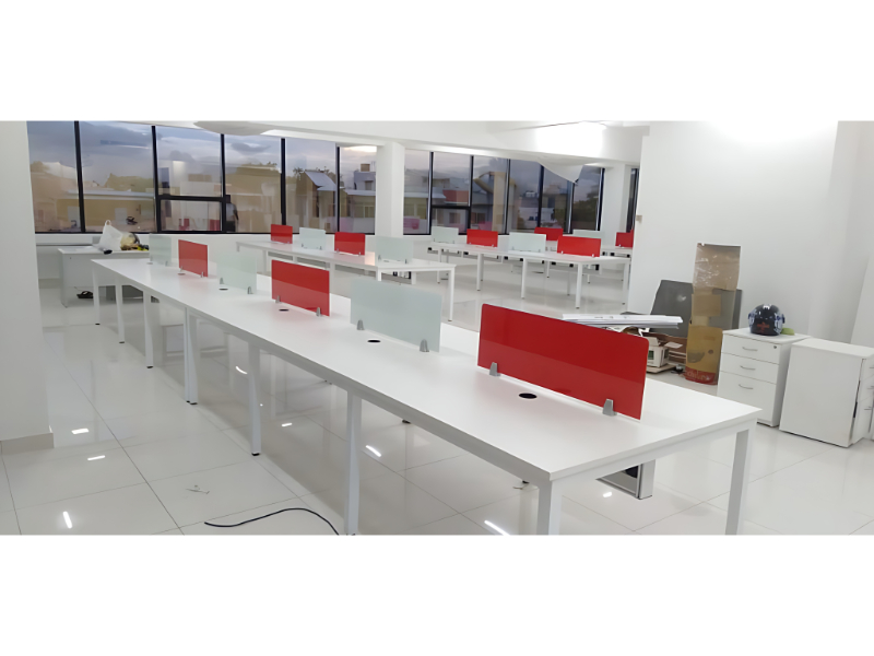 Linear Office Workstation Layout With Red And Frosted Glass Divider Panels