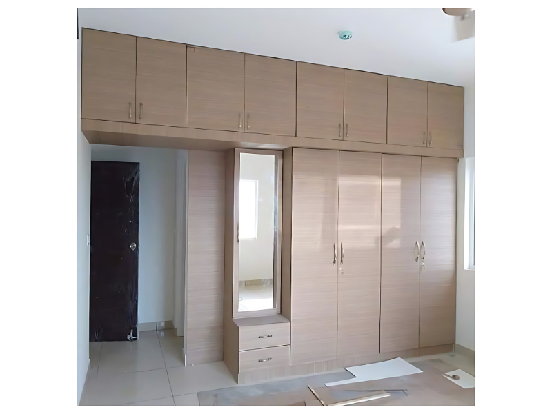 Overhead Storage Wardrobe With Dressing Unit In Contemporary Bedroom Layout