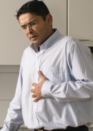 A sick Indian man clutching his stomach