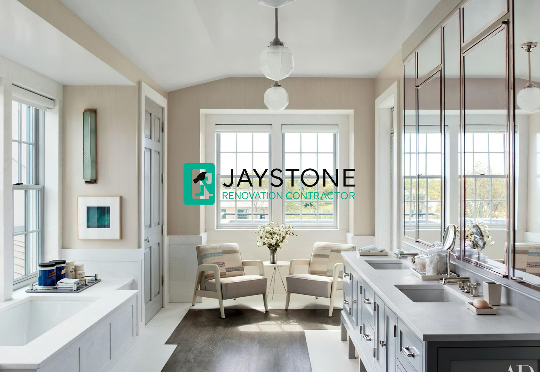 Bathroom with twin chairs, large mirrors, and Jaystone logo promoting renovation services