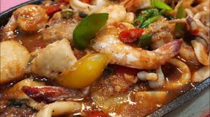Sizzling Seafood Served with Rice and Salad