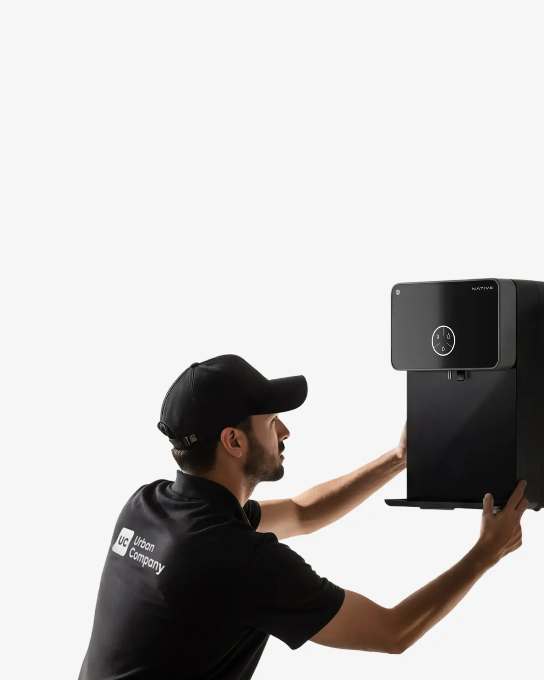 An Urban Company technician installing a Native M1 on a kitchen wall.