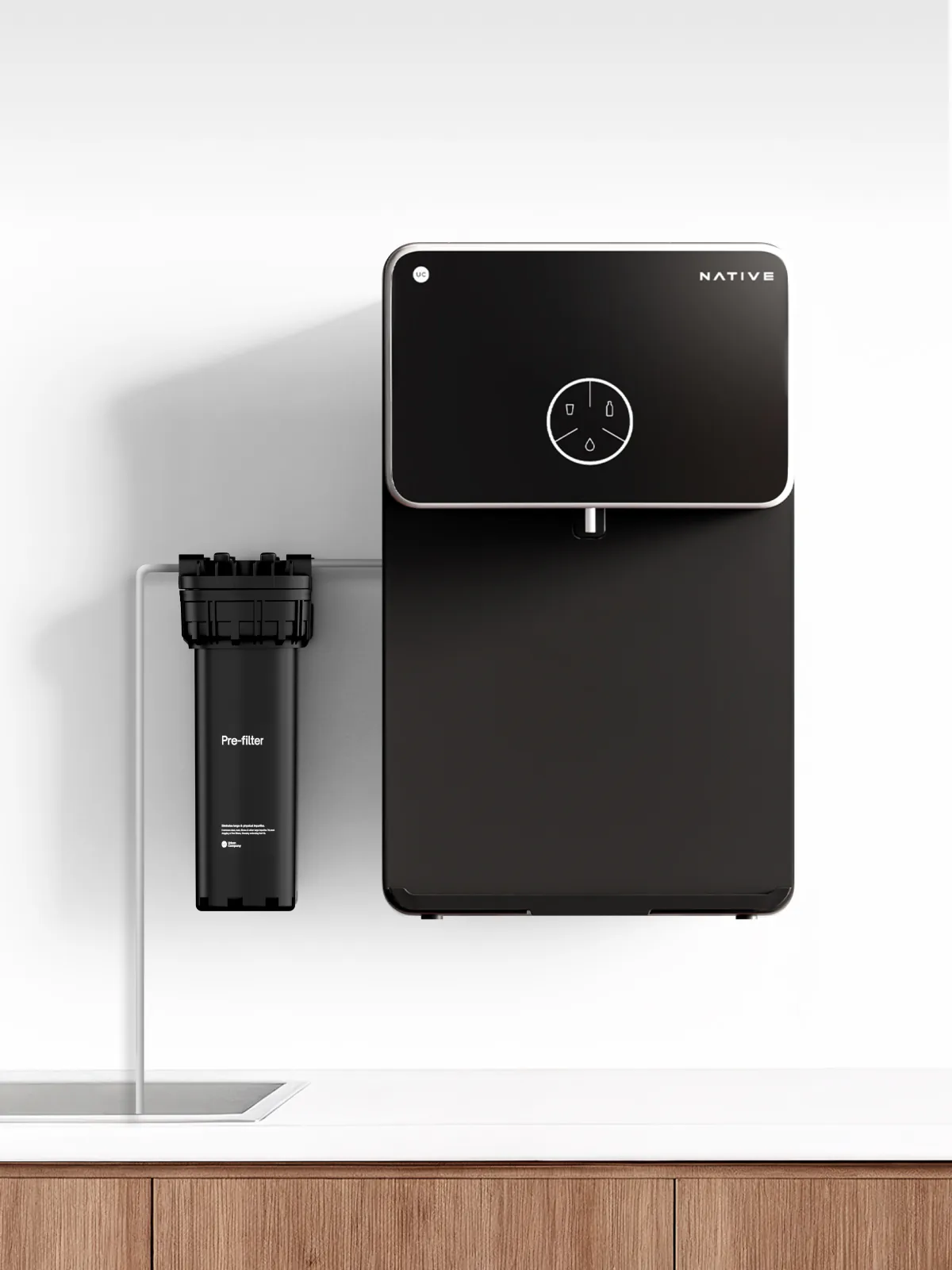 Wall-mounted Native M2 Pro beside a pre-filter joined by a thin inlet pipe.