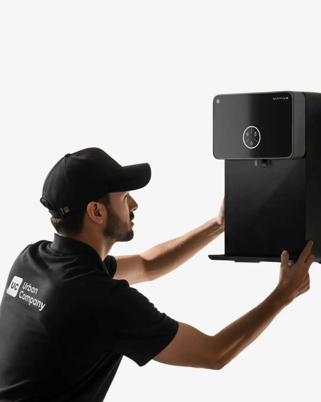 An Urban Company technician installing a Native M2 Pro on a kitchen wall.