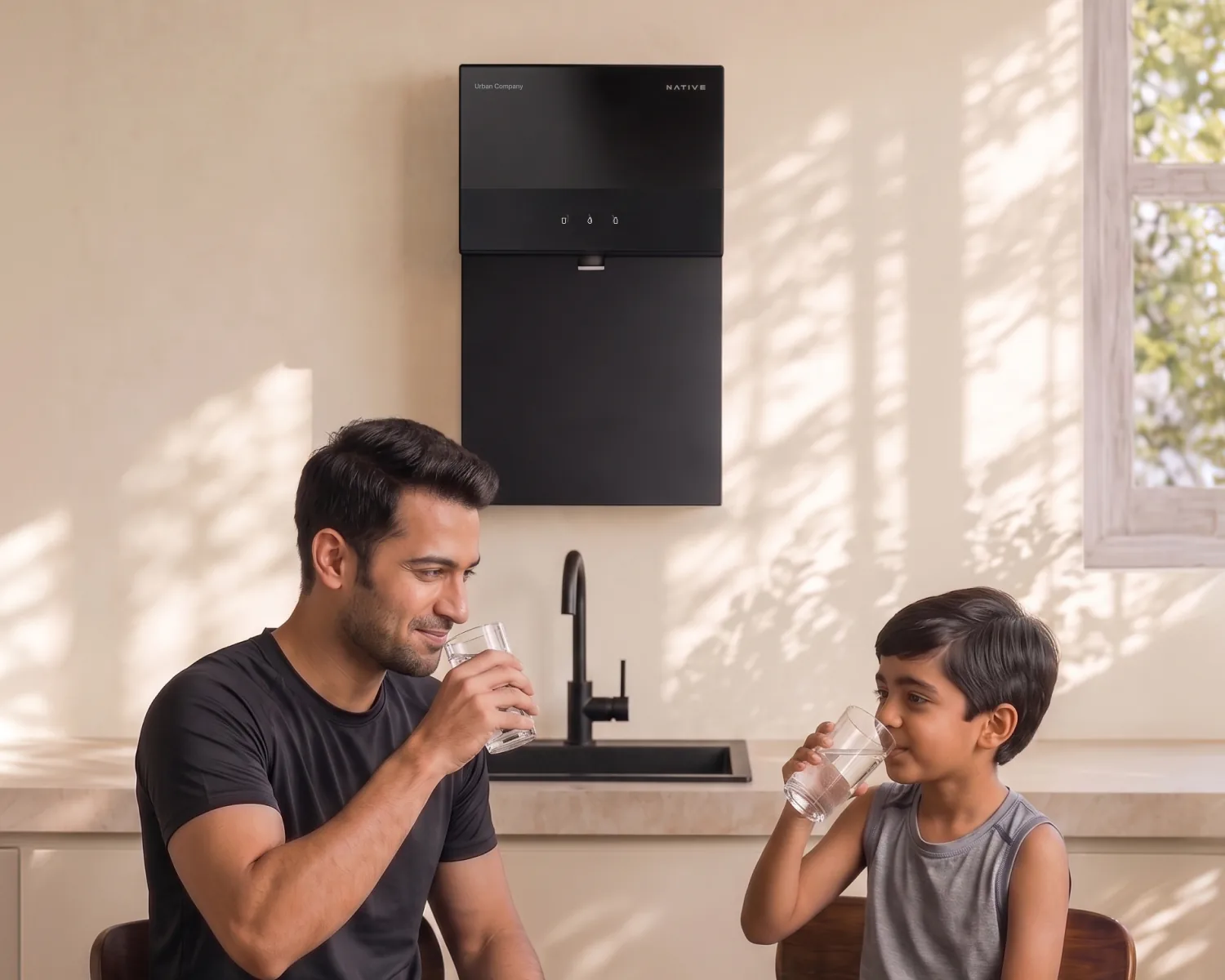 A father and son drinking water at the table below a wall-mounted Native M3.