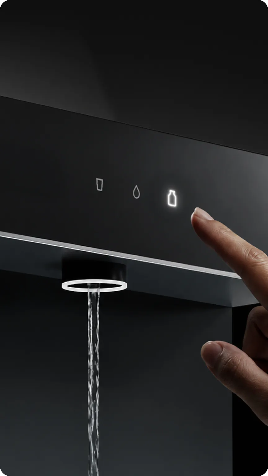 A finger touching the Native M3 touch panel as water pours from the tap.