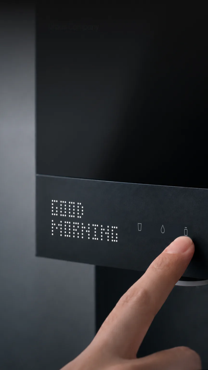 Finger tapping the Native M3 Pro as its display reads GOOD MORNING.