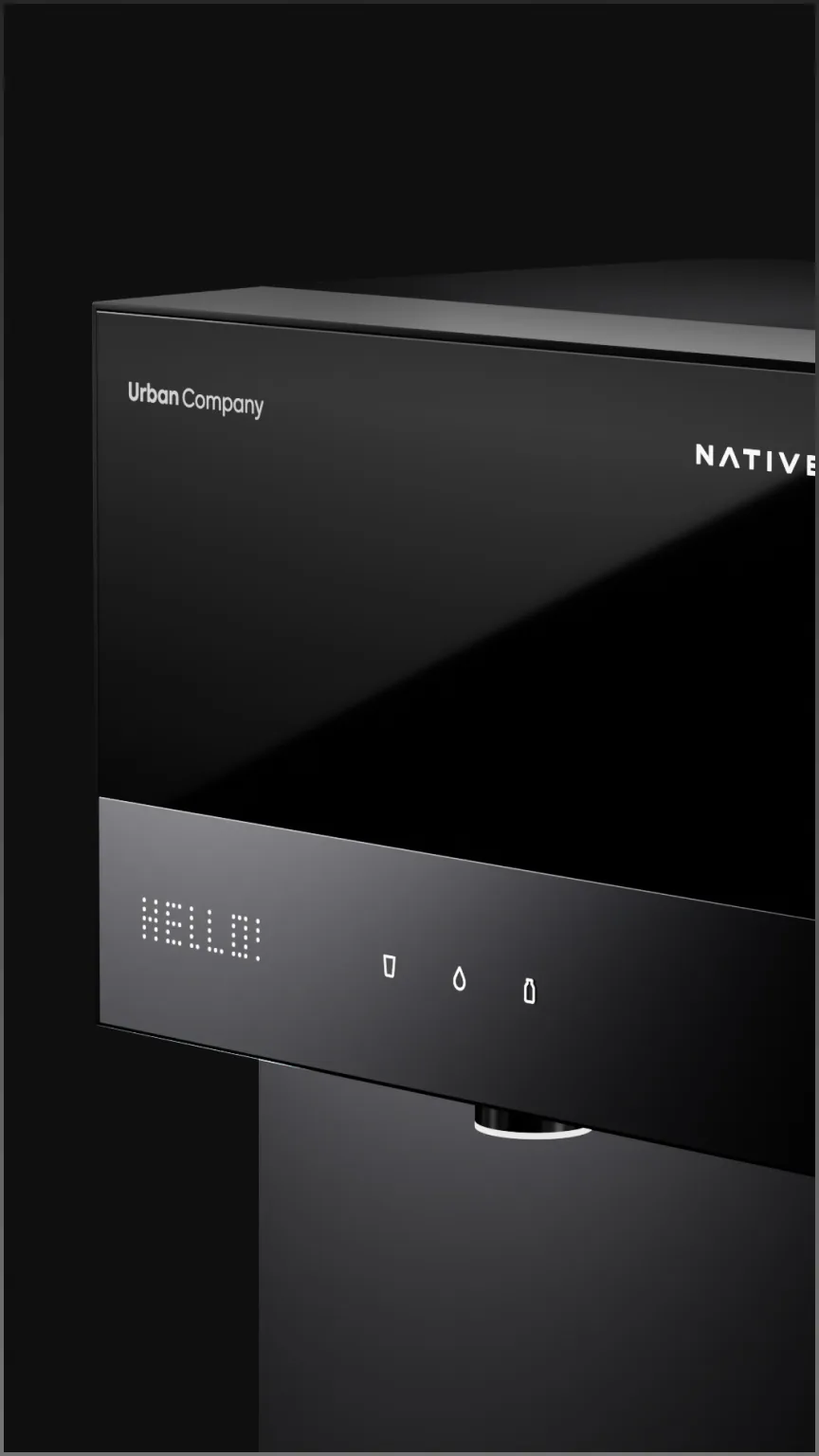 Angled close-up of the Native M3 Pro's matte black body and glass top, the display reading HELLO.
