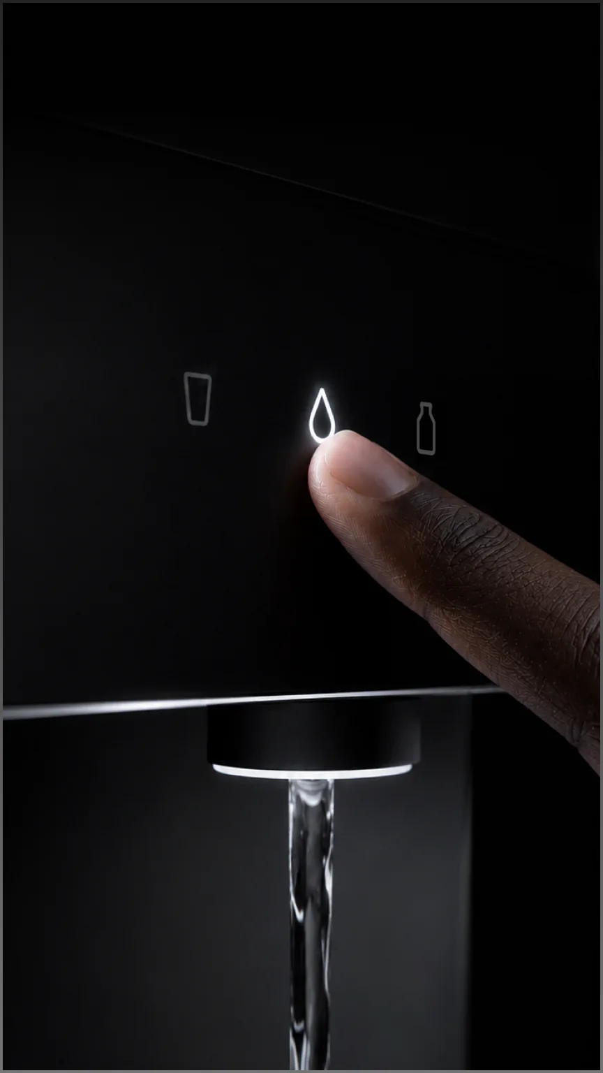 Finger touching the water icon on the Native M3 Pro as water streams from the spout.