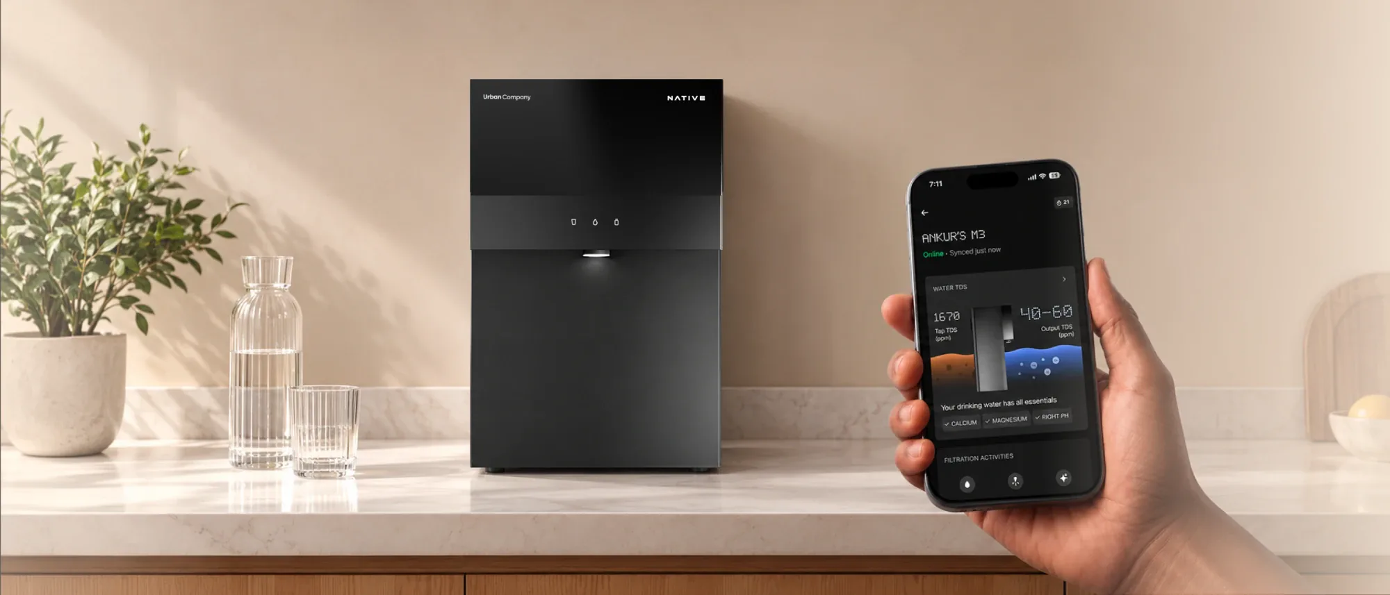 A hand holds a phone showing Native M3 in the UC app (tap TDS 1670, output TDS 40–60 ppm) beside the purifier on a kitchen counter.