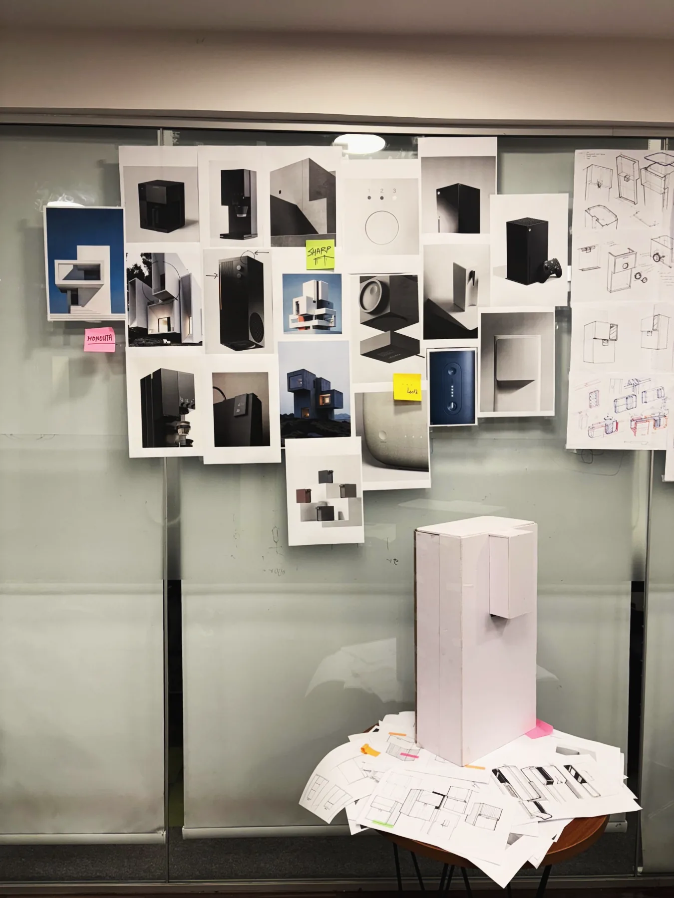 A mood board above a cardboard mock-up of a purifier