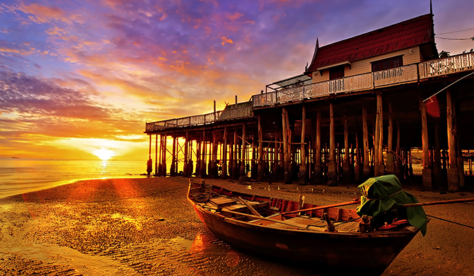 A fishing boat on Hua Hin beach at dawn